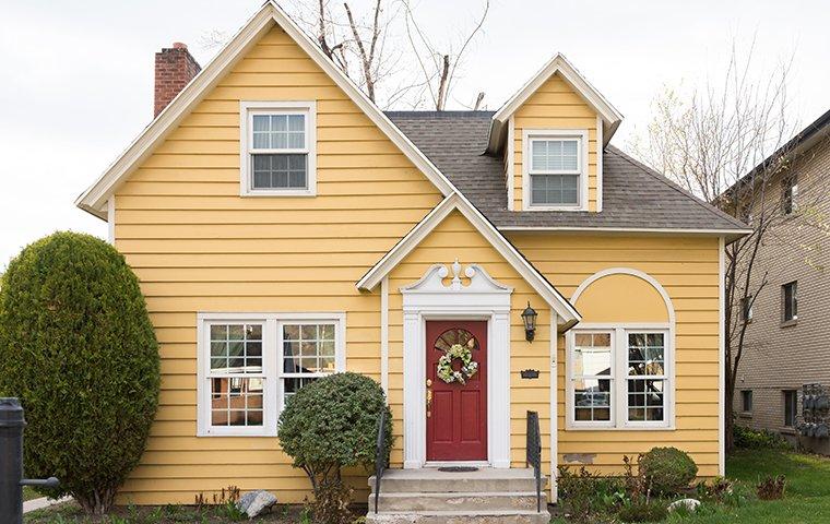 Street view of a yellow home.